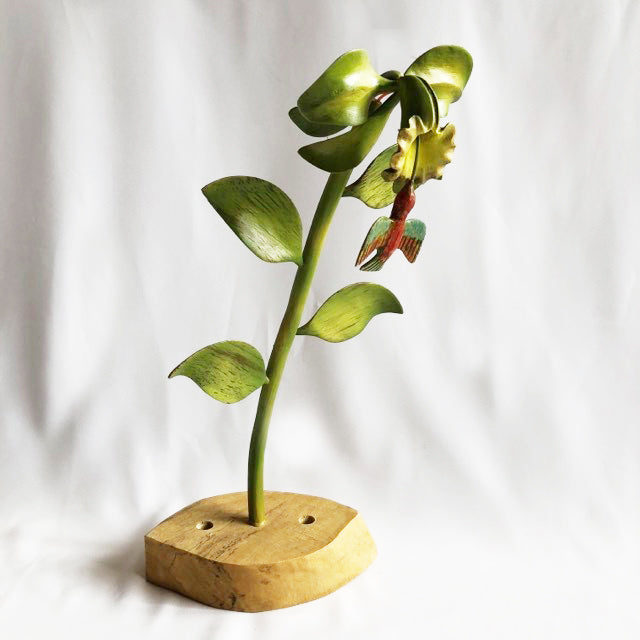 Flower with hummingbird carved in wood.