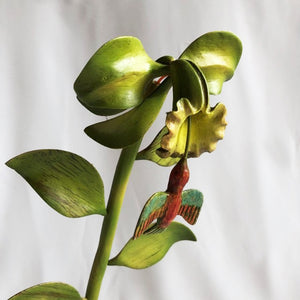 Flower with hummingbird carved in wood.