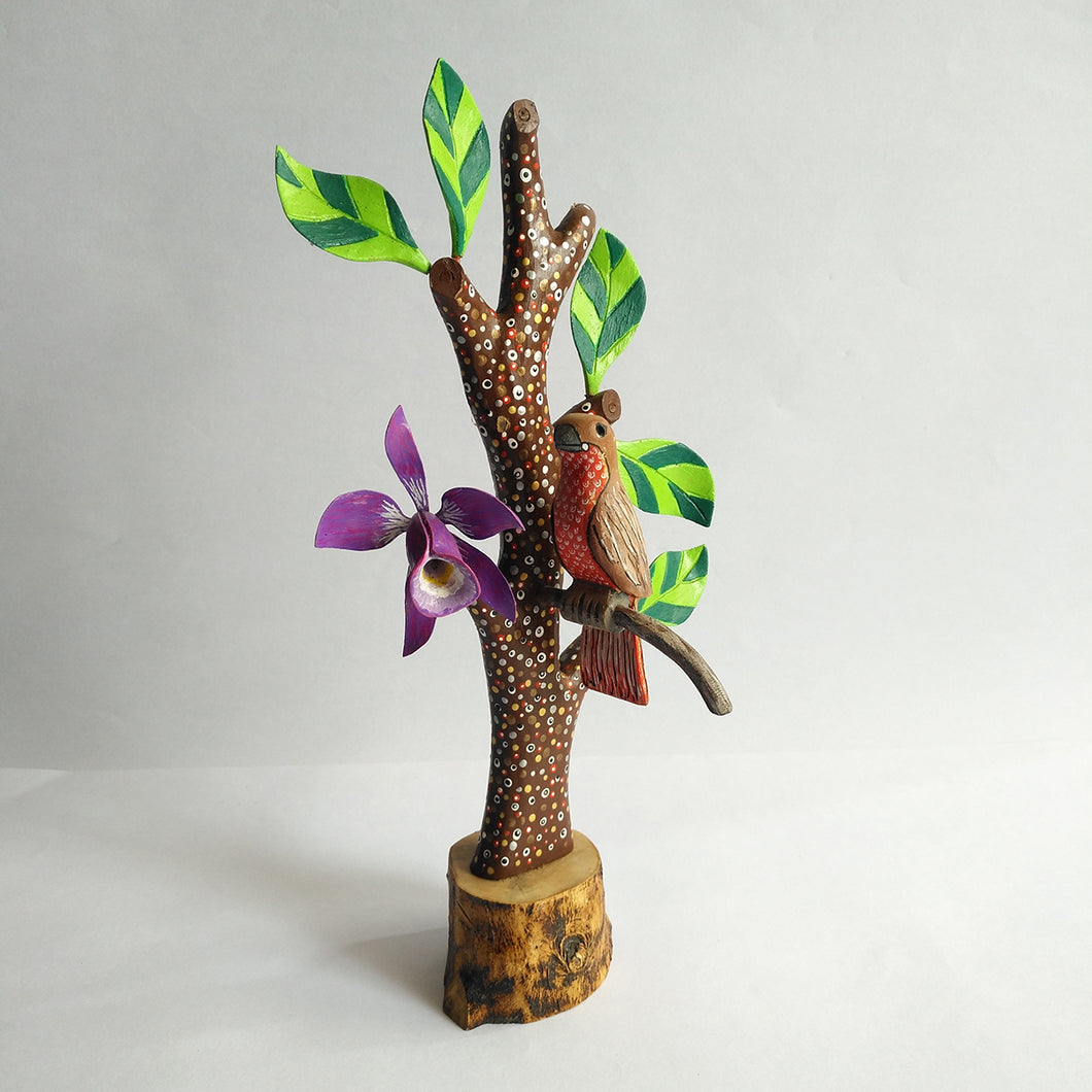 Tree in wood with bird and flower